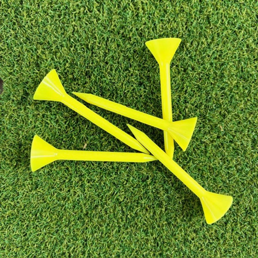 Yellow Martini golf tees on a green grass background
