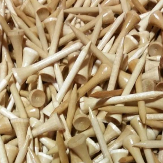 A collection of wooden golf tees in natural wood color, mixed with some in a white color, filling the entire frame.