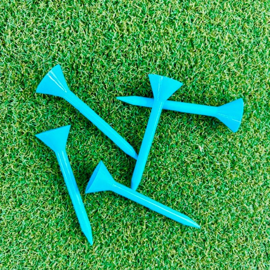 Blue Martini golf tees on a green grass background