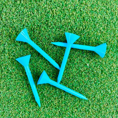 Blue Martini golf tees on a green grass background