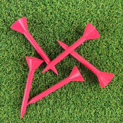 Pink Martini golf tees on a green grass background